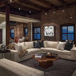 Modern inredning av ett allrum med öppen planlösning, med betonggolv