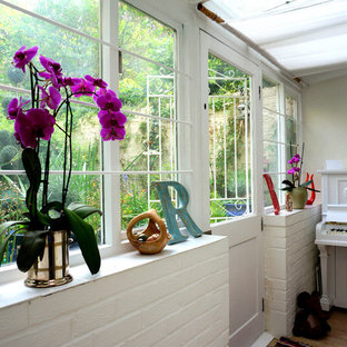 Photo of an eclectic entryway in London with a dutch front door.
