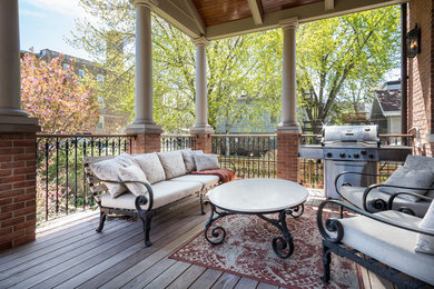 Patio - large transitional backyard patio idea in Chicago with a roof extension