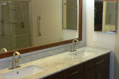 Mid-sized elegant master gray tile and ceramic tile ceramic tile and gray floor sliding shower door photo in Philadelphia with furniture-like cabinets, dark wood cabinets, a two-piece toilet, gray walls, an undermount sink and marble countertops