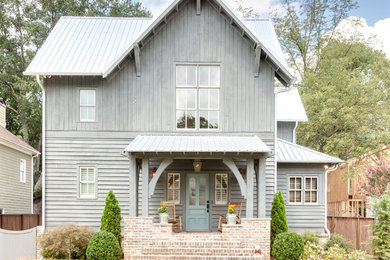 Design ideas for a mid-sized country two-storey grey exterior in Atlanta with a gable roof and wood siding.