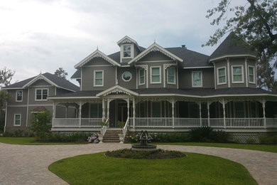 Inspiration for a large traditional three-storey grey house exterior in Jacksonville with mixed siding, a gable roof and a shingle roof.
