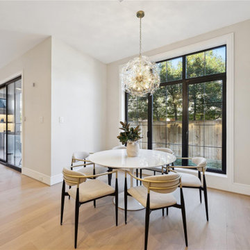 Dining room with sputnik chandelier and steel-framed windows