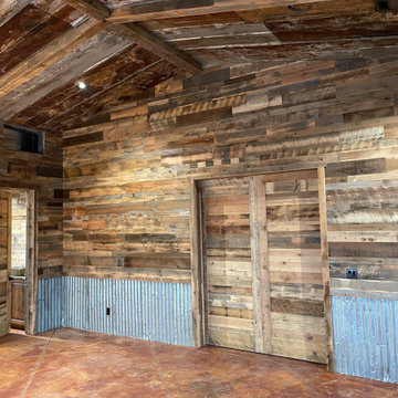 Man Cave- Reclaimed wood walls, rusty metal, barn doors