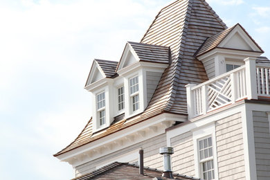 Elegant gray wood exterior home photo in Boston with a hip roof