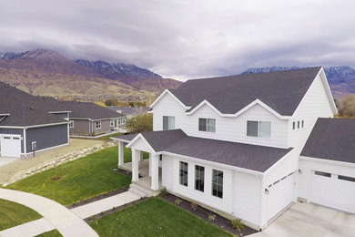 Inspiration for a mid-sized cottage yellow two-story concrete fiberboard exterior home remodel in Salt Lake City with a shingle roof