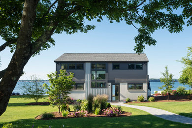 Example of a mid-sized mid-century modern gray two-story wood exterior home design in Providence