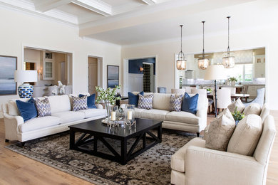 Inspiration for a large transitional open concept medium tone wood floor and brown floor living room remodel in San Diego with beige walls