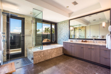 Large trendy master brown tile and stone tile marble floor walk-in shower photo in Hawaii with an undermount sink, flat-panel cabinets, distressed cabinets, granite countertops, an undermount tub, a one-piece toilet and multicolored walls