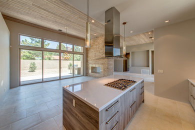 Eat-in kitchen - large contemporary galley ceramic tile and beige floor eat-in kitchen idea in Phoenix with flat-panel cabinets, distressed cabinets, an island, quartzite countertops and beige backsplash