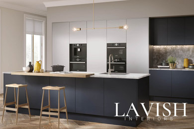 Photo of a large contemporary single-wall kitchen/diner in London with flat-panel cabinets, blue cabinets, granite worktops, black appliances and an island.