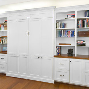 Photo of a large modern open plan home cinema in San Francisco with white walls, a built-in media unit, dark hardwood flooring and brown floors.