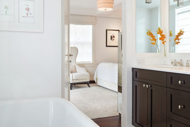 Mid-sized elegant master marble floor bathroom photo in New York with recessed-panel cabinets, dark wood cabinets, white walls, an undermount sink and a one-piece toilet