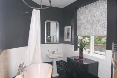 Example of a trendy black tile and porcelain tile claw-foot bathtub design in London with a pedestal sink