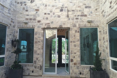 Example of a trendy beige two-story adobe exterior home design in Phoenix