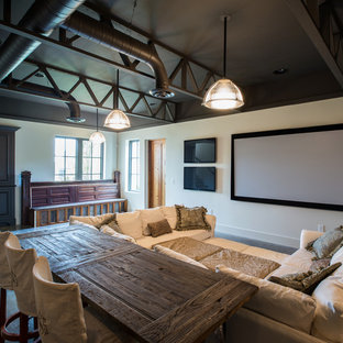 Inspiration for a rustic home cinema in Nashville with concrete flooring, a projector screen and grey floors.