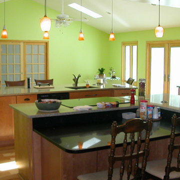 Pendant lights and bright windows perk up the space in this accessible kitchen.