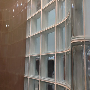 Curved glass block shower wall with high gloss shower wall panels