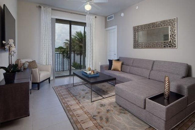 Living room - small contemporary open concept porcelain tile and beige floor living room idea in Miami with beige walls, no fireplace and a wall-mounted tv