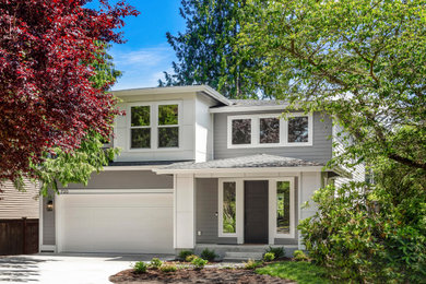 Example of a transitional gray two-story concrete fiberboard house exterior design in Seattle with a hip roof, a shingle roof and a black roof