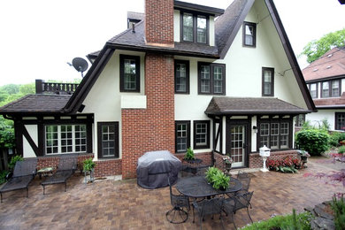 Example of a mid-sized classic white three-story mixed siding gable roof design in Other