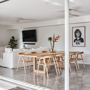 Beach style open plan dining in Gold Coast - Tweed with white walls and grey floor.