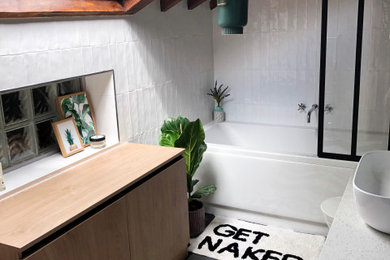 Design ideas for a small contemporary kids bathroom in London with white tile, white walls, cement tiles, a console sink, black floor and an open shower.