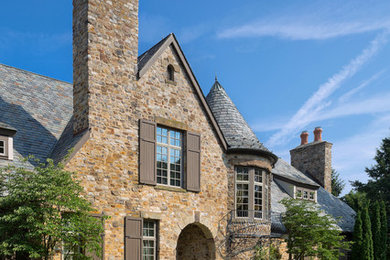 Rustic multicolored two-story stone exterior home idea in Cleveland with a shingle roof