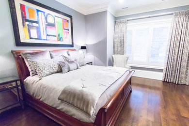Inspiration for a mid-sized timeless master medium tone wood floor bedroom remodel in Baltimore with gray walls