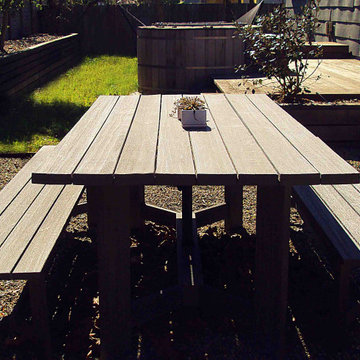 Alfresco dining area with crushed rock floor and newly planted edible screen