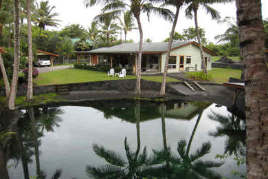 Example of a beach style home design design in Hawaii