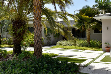 Example of a huge trendy purple one-story stucco house exterior design in Miami with a hip roof and a tile roof