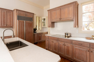Eat-in kitchen - mid-sized transitional u-shaped medium tone wood floor eat-in kitchen idea in Dallas with a drop-in sink, beaded inset cabinets, distressed cabinets, quartz countertops, white backsplash, quartz backsplash, paneled appliances, an island and white countertops