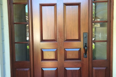 Inspiration for a modern entryway remodel in Santa Barbara with a dark wood front door