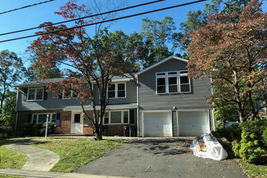 Large traditional gray two-story mixed siding exterior home idea in New York with a shingle roof