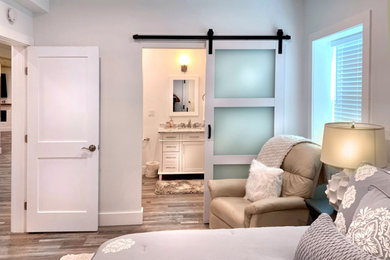 Basement - large transitional walk-out vinyl floor, gray floor, exposed beam and shiplap wall basement idea in Atlanta with a home theater, white walls, a standard fireplace and a shiplap fireplace