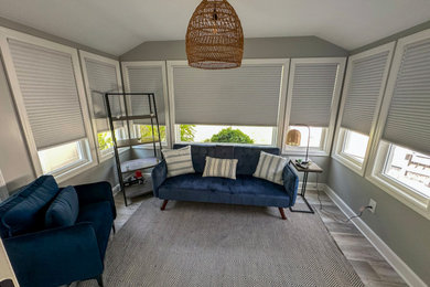 Family room - small transitional open concept vinyl floor and gray floor family room idea in New York with gray walls