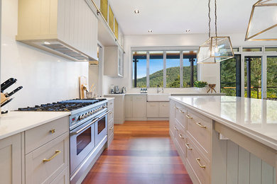 Photo of a large traditional open plan kitchen in Central Coast with shaker cabinets, quartz benchtops and with island.