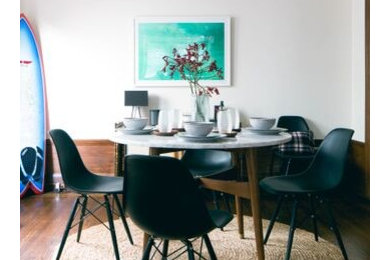This is an example of a mid-sized contemporary separate dining room in Los Angeles with white walls, medium hardwood floors and no fireplace.