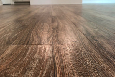 Kitchen - mid-sized transitional laminate floor and brown floor kitchen idea in Other