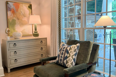 Transitional medium tone wood floor living room photo in Charlotte with white walls