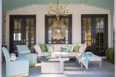 Mid-sized cottage concrete back porch idea in DC Metro with a fire pit and a roof extension
