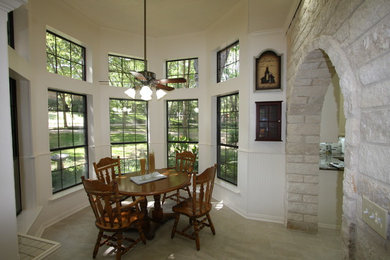 Inspiration for a mid-sized timeless gray floor dining room remodel in Dallas with white walls