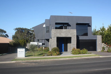 Large contemporary two-storey grey exterior in Geelong with wood siding and a flat roof.