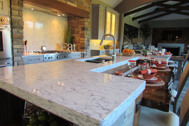 Example of a huge transitional eat-in kitchen design in Detroit with quartz countertops and an island