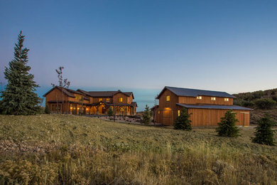 Inspiration for a large rustic brown two-story wood gable roof remodel in Salt Lake City