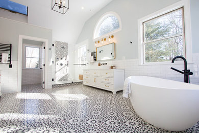Large tuscan master black and white tile and subway tile cement tile floor and black floor bathroom photo in Boston with shaker cabinets, white cabinets, a two-piece toilet, blue walls, a vessel sink, marble countertops, a hinged shower door and white countertops