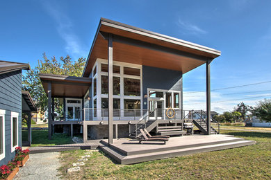 Example of a small trendy blue one-story concrete fiberboard house exterior design in Seattle with a shed roof and a metal roof