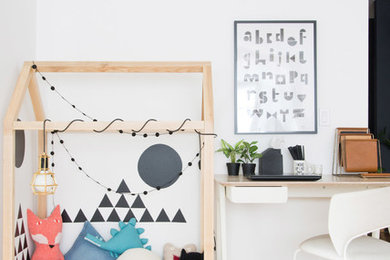Inspiration for a scandinavian gender-neutral kids' playroom in Other with white walls, plywood floors and brown floor.