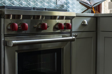 Mid-sized elegant medium tone wood floor kitchen photo in Omaha with an undermount sink, shaker cabinets, blue backsplash, ceramic backsplash, stainless steel appliances and white countertops